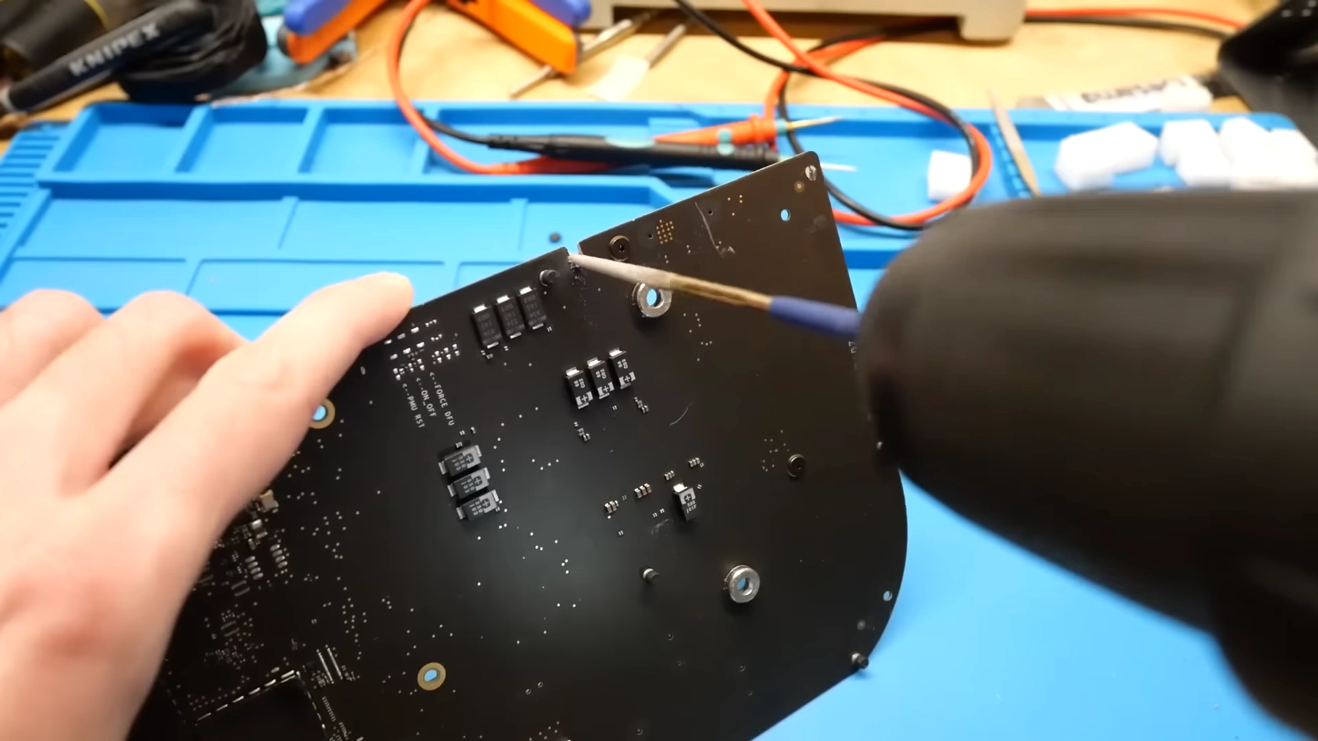 dosdude1 using a drill with a file on the end of it to file out a crack in an Apple Developer Transition Kit 