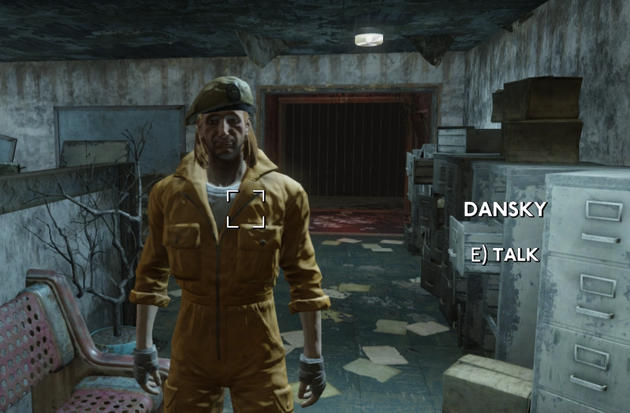 fallout london npc called dansky wearing a yellow jumpsuit, long blonde hair and a beret
