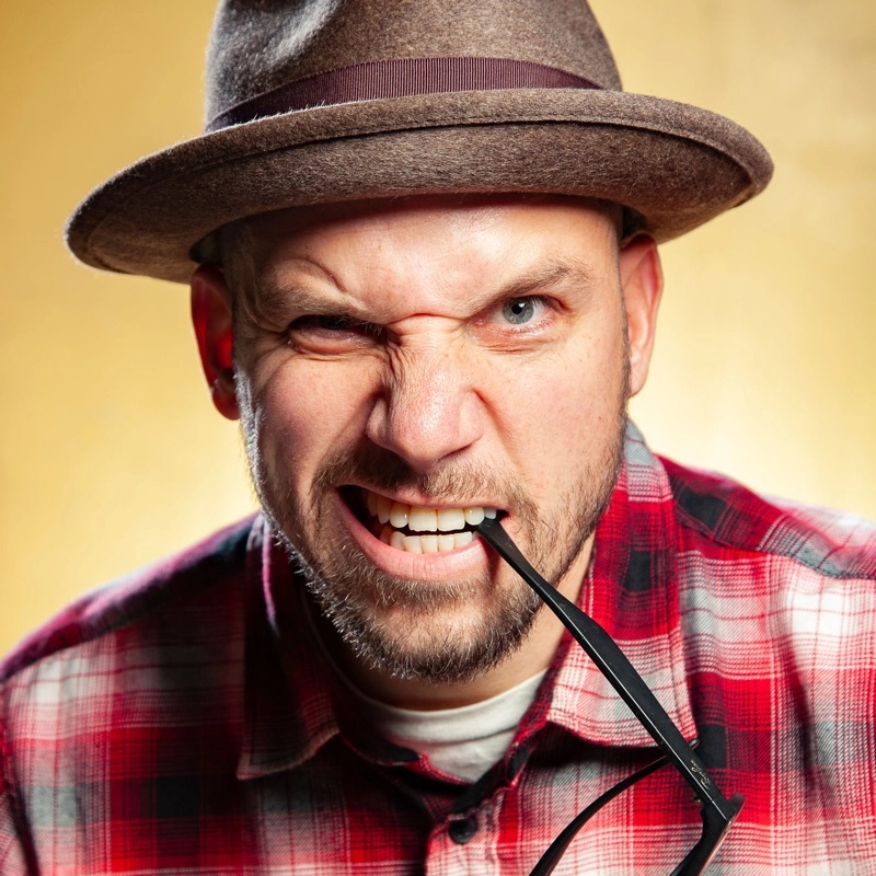 picture of epiclloyd with a pair of glasses in his mouth and a fedora