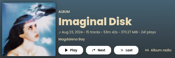 Imaginal Disk by Magdalena Bay with an album cover of a woman looking up at the sky and a dark hand taking an optical disc out of her head